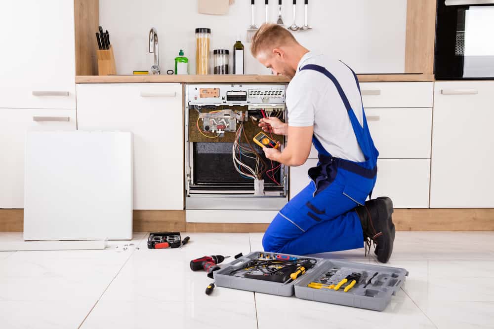 technician testing dishwasher. Appliance repair Queens, NY