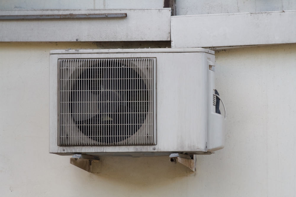 outdoor air conditioner mounted to wall.