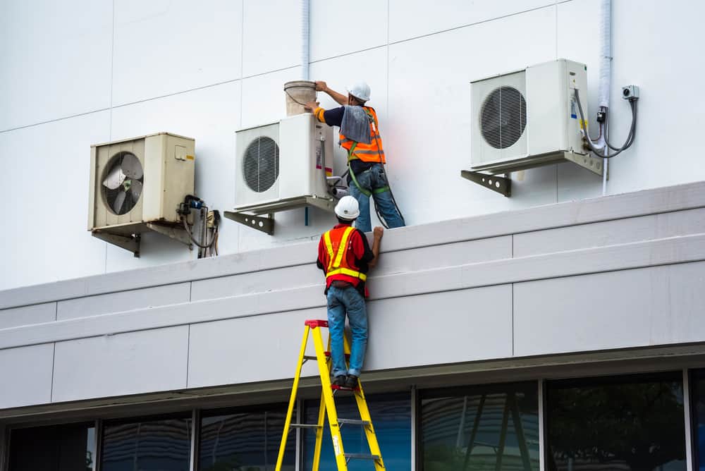 technicians working on commercial ac units.